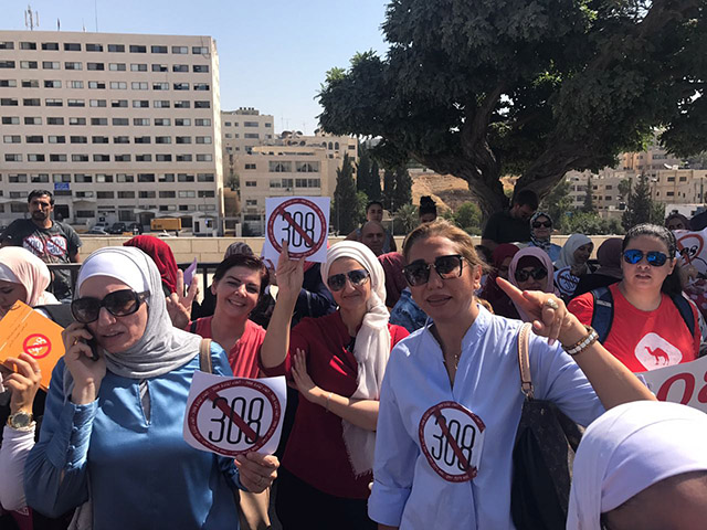 Activists stage a sit-in in front of Parliament on Tuesday ahead of a morning session that ended with the Lower House voting to abolish Article 308 of the Penal Code